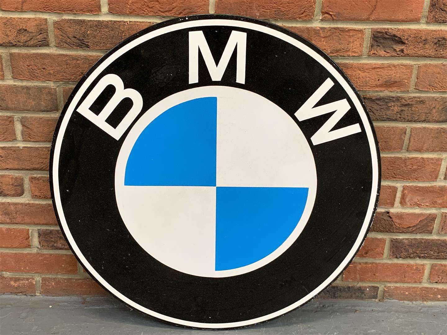 <p>Pair of BMW emblems painted on board</p>