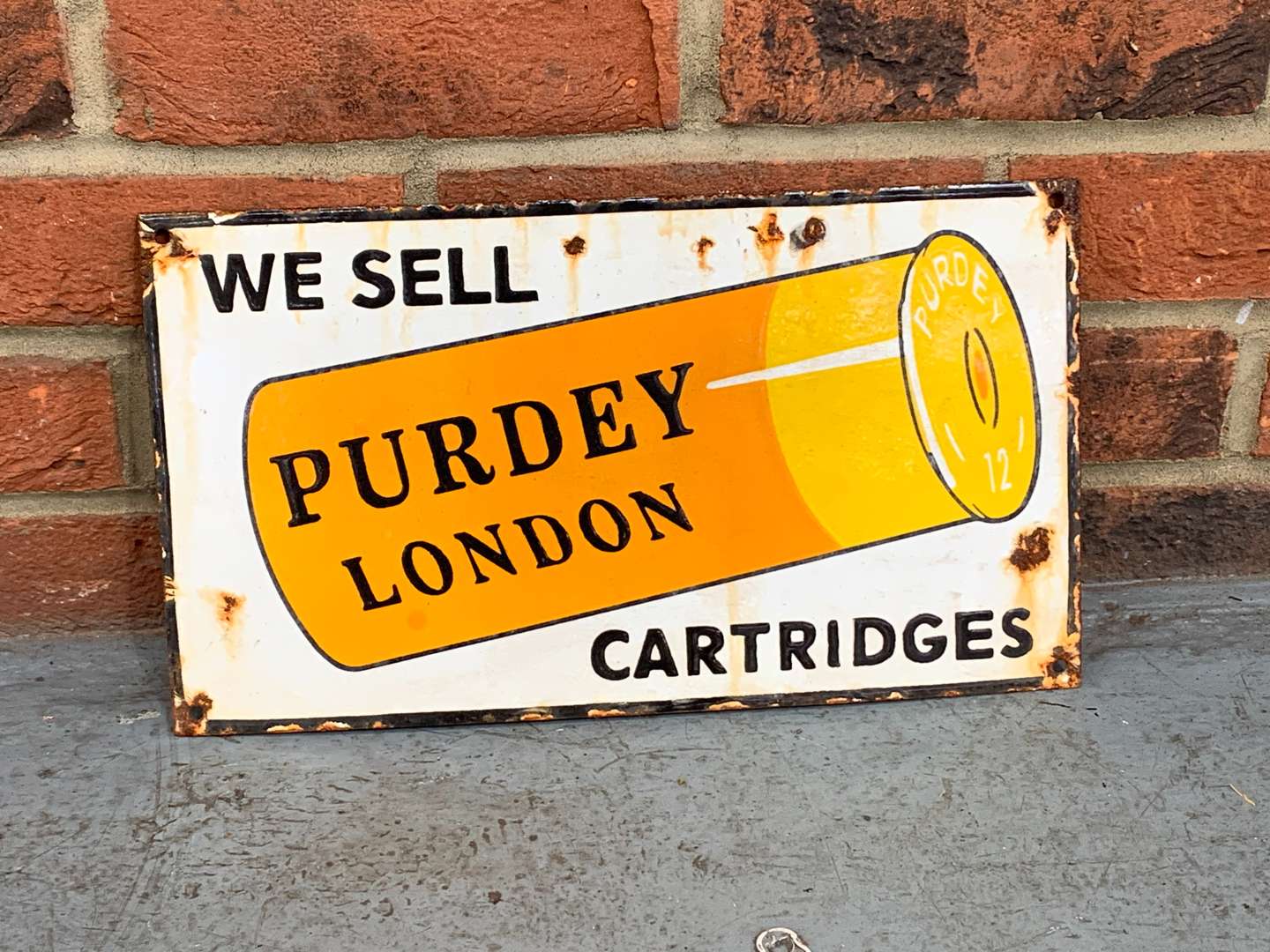 <p>We Sell Purdey Cartridges Enamel Sign</p>