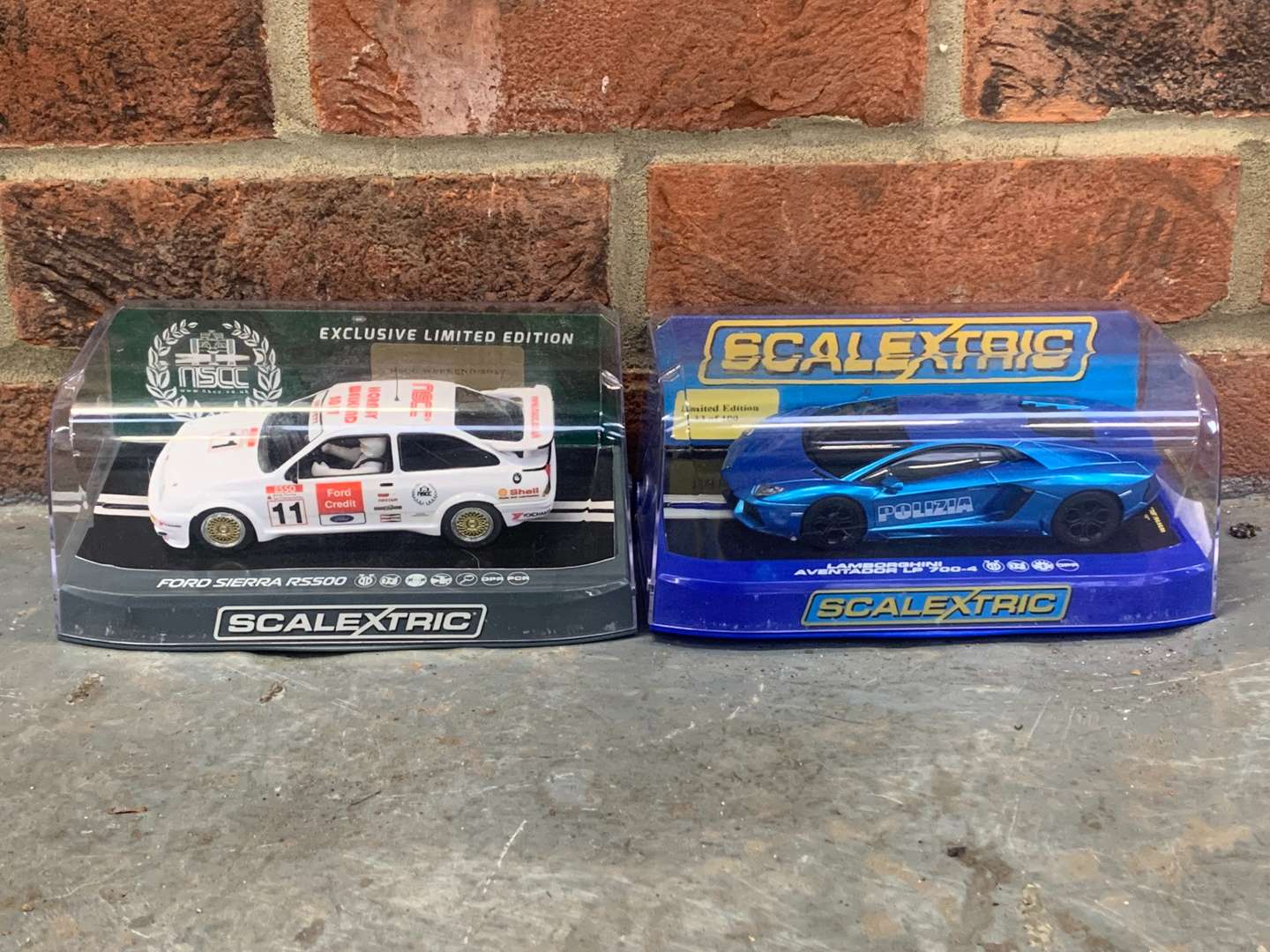 <p>Boxed Scalextric Ford Sierra RS500 and Lamborghini Aventador Cars</p>