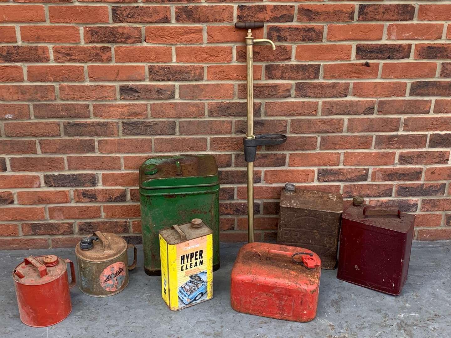 <p>Vintage Brass Pump and Seven Oil Cans (8)</p>