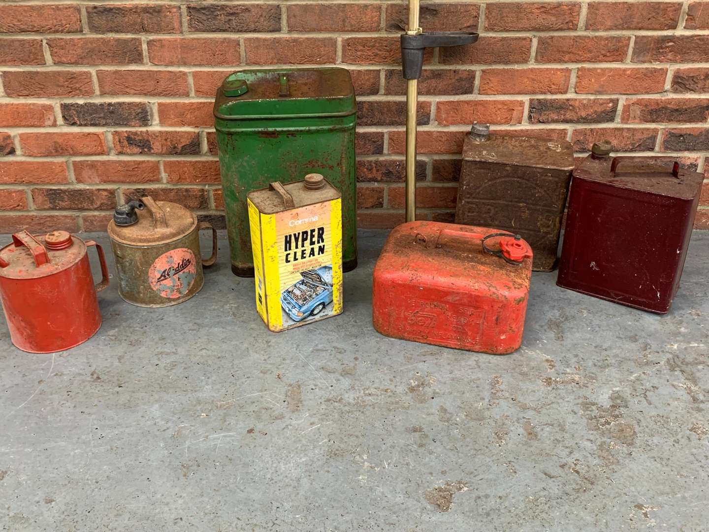 <p>Vintage Brass Pump and Seven Oil Cans (8)</p>